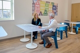 Staff members sitting at a table at the treatment location