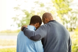 Father with his hand around a boys back