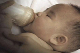 Baby feeding from bottle