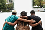 Three teens with arms around each other