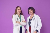 Two physician-researchers smiling.