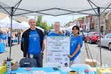 Community Impact team at an event with a resources partner sign.