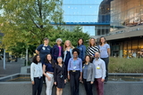A group of physicians are smiling for the group photo.