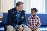 Doctor and patient smiling at each other.