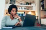 Black woman with green shirt at computer