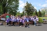 Group of people in matching shirts at a fundraising event.