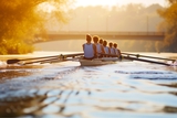 People rowing a boat on a river.