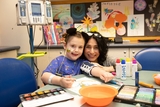 Young girl with therapist playing