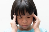 Girl holding her head