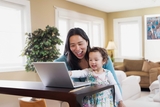 Mother with daughter on computer