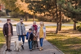 Multi-generational family walking outside on a fall day