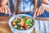 Healthy Vegetarian Diets for Teens young woman eating salad