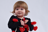 zoey holding hearts on string