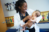 Female physician with baby