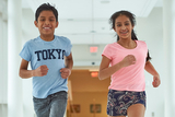 Young boy and girl running down hall Young boy and girl running down hall