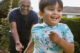 Chasing grandson in the garden during outdoors playtime.