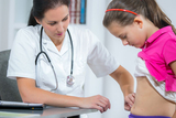 Doctor examining a child's stomach