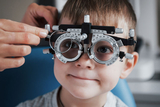 Child Eye Doctor boy getting eye exam