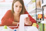 upset woman holding grocery receipt