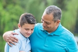 Father with arm around son