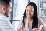 Doctor talking to teen patient