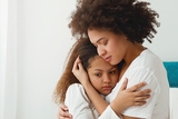 Mother hugging distraught daughter Mother hugging distraught daughter