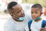 Father consoling young son Father consoling young son