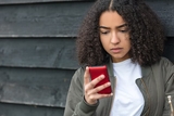 Teen girl looking at her smartphone