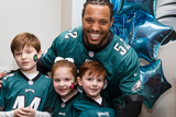 Najee Goode poses with kids at the 8th annual Huddle Up for Autism Najee Goode poses with kids at the 8th annual Huddle Up for Autism