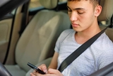 Teen driver looking at phone Teen driver looking at phone