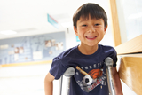 young boy with crutches