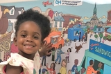 CHOP patient in front of mural CHOP patient in front of mural