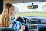 Female teenager behind the steering wheel of a car Female teenager behind the steering wheel of a car