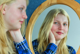 Tips to Promote a Healthy Body Image Girl smiling in mirror