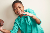 Zion holding a football Zion holding a football