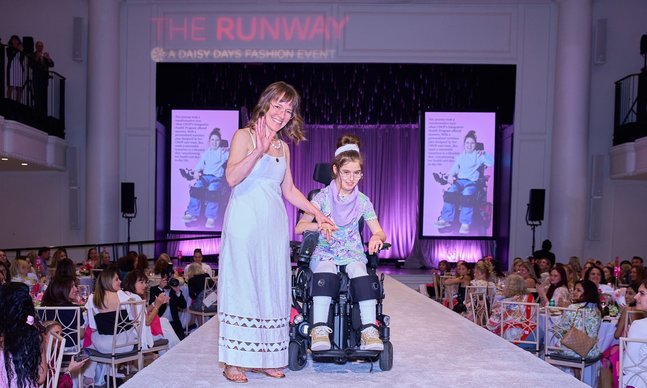 CHOP Patient, Bea, modeling in the patient fashion show with her mother
