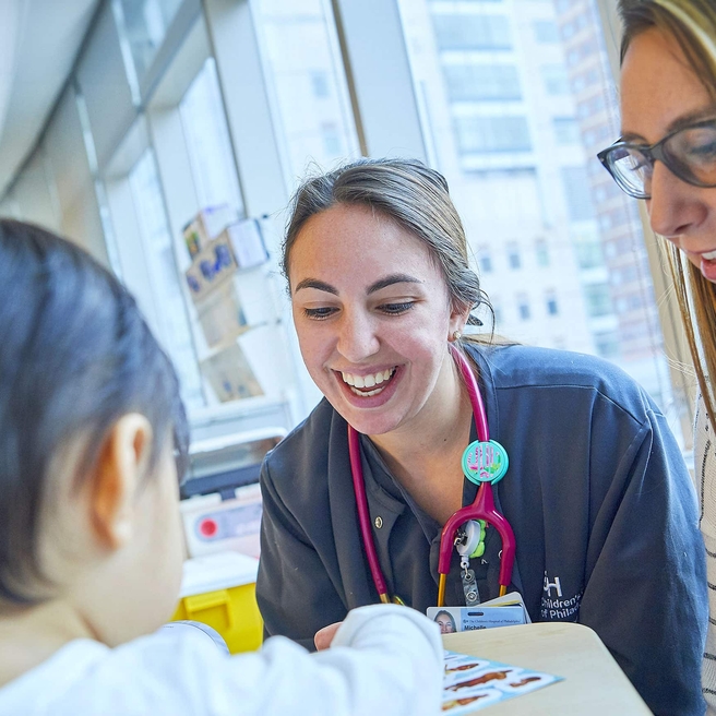 Health care staff smiling while caring for a patient
