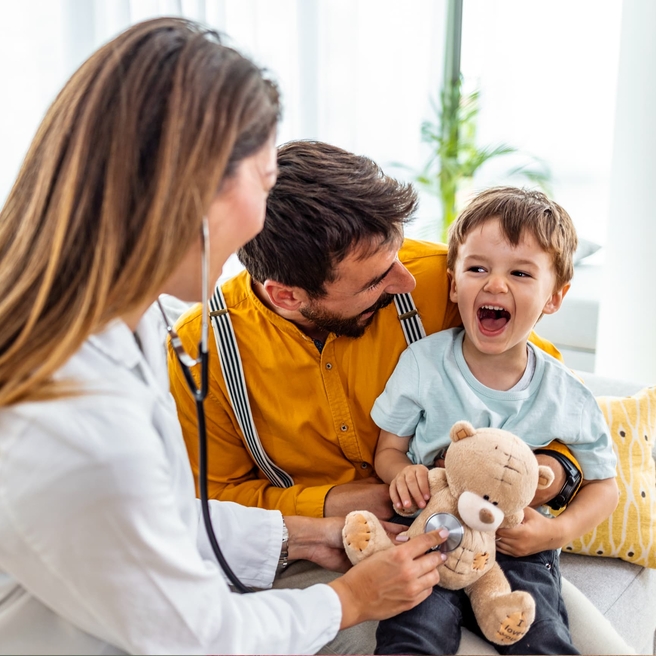 Little boy at doctor appointment with his dad.