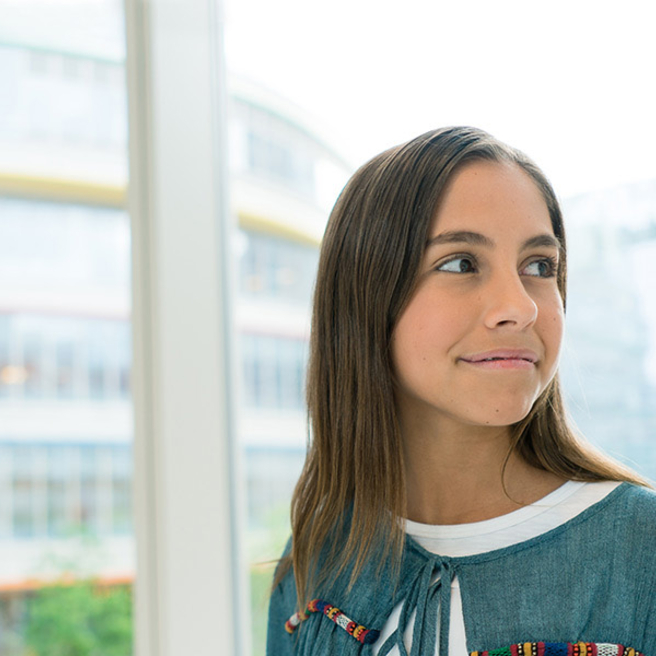 young girl looking over her shoulder