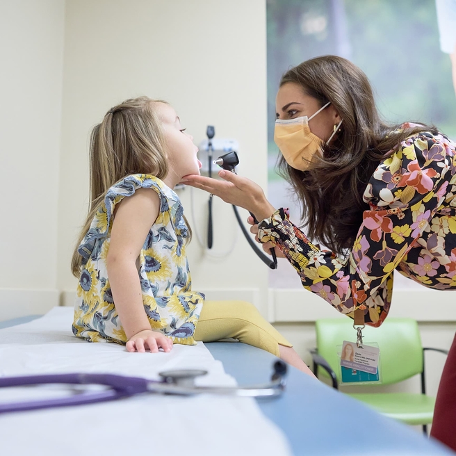 Doctor doing an exam to his young female patient.