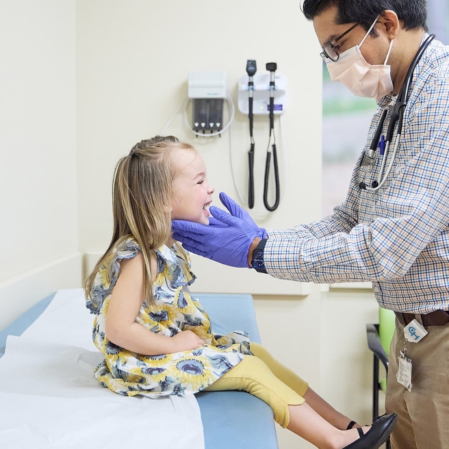 Doctor doing an exam to his young female patient.