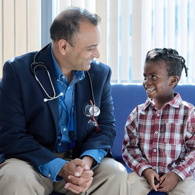 Doctor and patient smiling at each other.
