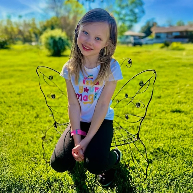 Cassidy in butterfly chair outside