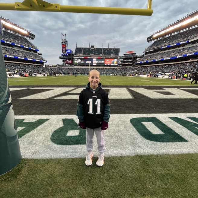 child standing on football field