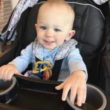 Young boy in stroller smiling