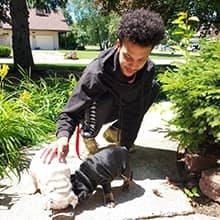 Cellie petting his dogs