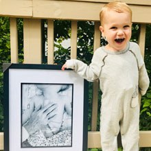 Finn with a photo of Dr. Spray touching his heart