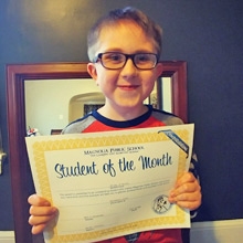 Riley holding Student of the Month award