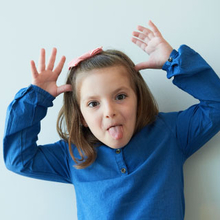 Young girl cancer patient making silly face