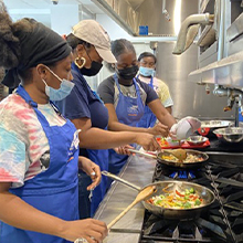 Summer camp participants in the kitchen